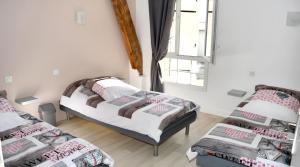 a room with three beds and a window at Grande maison accueillante à Saint-Épain avec salle de réception in Saint-Épain