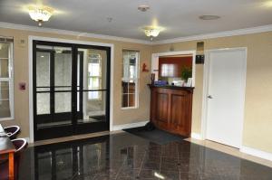 a hallway with a door and a counter in a building at SureStay Hotel by Best Western Castro Valley in Castro Valley