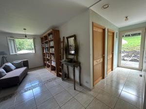 a living room with a couch and a mirror at Villa de charme en Pays Catalan in Le Tech +2 photos