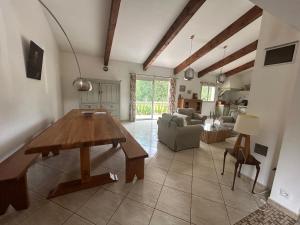 a living room with a table and a couch at Villa de charme en Pays Catalan in Le Tech
