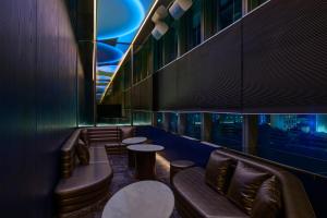 a restaurant with couches and tables and a view of a city at InterContinental Taichung by IHG in Taichung