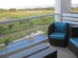 a balcony with a chair and a view of a pool at Panoramic Ocean view Playa Blanca Suite in Playa Blanca