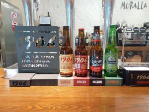 a group of beer bottles sitting on top of a book at La Muralla de Gredos Hotel Rural in Madrigal de la Vera
