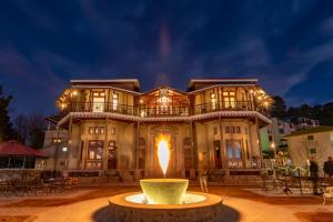 a large building with a fountain in front of it at Cecil by Pearl Continental in Murree
