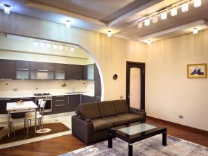 a living room with a couch and a table at Serenity apart by Bakuapart in Baku