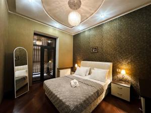 a bedroom with a bed with a stuffed animal on it at Serenity apart by Bakuapart in Baku