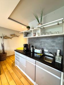 a kitchen with a sink and a counter top at Ferienwohnung Strandperle - nur 150m zum Strand in Scharbeutz