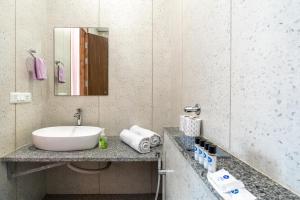 a bathroom with a sink and a mirror at Homlee-Gokul 3BHK Flat-Lift-Parking-vaishali metro in Ghaziabad +55 photos