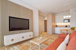 a living room with a couch and a flat screen tv at Bel mare aqua 2 Aquapark in Międzyzdroje