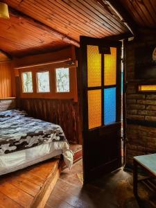 Postel nebo postele na pokoji v ubytování Refugio Aldea Infinita