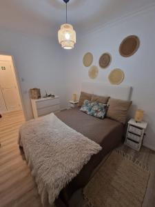 a bedroom with a large bed with a rug at Apartamento em Quarteira in Quarteira