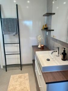 a kitchen with a sink and a towel rack at Beautifull house with 7 bedrooms in Sandefjord