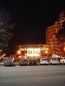 a carousel with lights in a city at night at Zit Flat Colon in Mar del Plata +9 photos