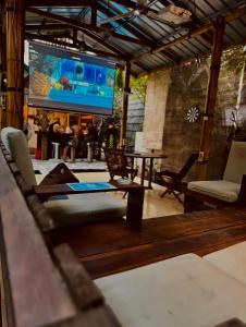 a living room with a couch and a large screen at Nelly Homestay Bungalows Gili Air in Gili Air +53 photos