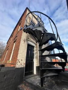 a spiral staircase on the side of a building at Cozy flat by Birmingham Canals & City Centre in Birmingham