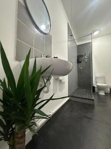 a bathroom with a sink and a toilet and a mirror at Cozy flat by Birmingham Canals & City Centre in Birmingham