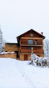a log cabin with snow on the ground at Holiday apartement Sentjur in Šentjur