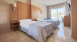 A bed or beds in a room at Hotel La Cala Finestrat