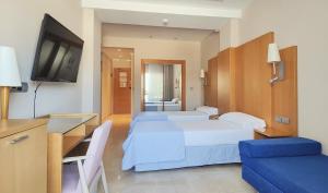 A bed or beds in a room at Hotel La Cala Finestrat