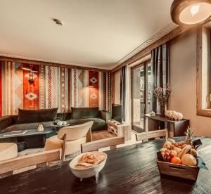 a living room with a couch and a table at Le Cairn in Val-d'Isère