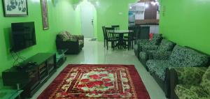 a living room with a couch and a table at Homestay Shah Alam in Shah Alam +5 photos