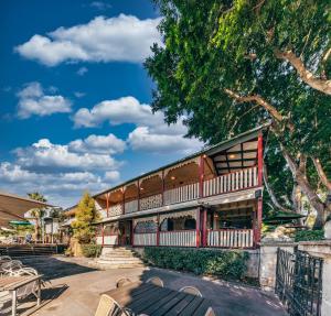 a building with tables and chairs in a courtyard at Wisemans Inn in Wisemans Ferry