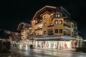 a tall building with a store in front of it at MANNI das Hotel in Mayrhofen