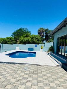a swimming pool in the middle of a patio at Omaha Luxury B&B & SPA in Mthatha