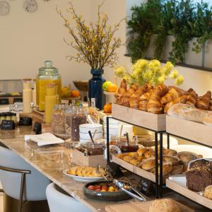 een buffet met gebak en brood op een tafel bij The Liman Hotel in Brussel