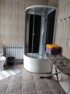 a bathroom with a shower with a large mirror at дом в Боровом Сарыбулак 4 комнатный in Vorobʼyëvka +7 photos