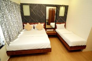 Postel nebo postele na pokoji v ubytování Hotel Abraj Inn