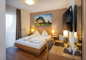 מיטה או מיטות בחדר ב-Vital-Hotel-Styria