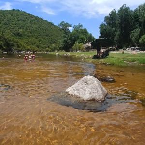 a rock in the middle of a river at La Calandria in Villa Serranita