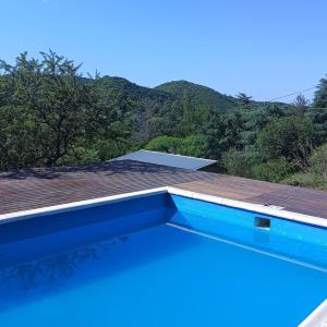 a swimming pool on the roof of a house at La Calandria in Villa Serranita