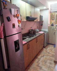 a kitchen with a purple refrigerator and a stove at La casita de jo in Cartagena de Indias