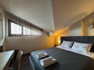a bedroom with a bed with two towels on it at TERRA Vista Penthouse near Pirin Golf and Bansko in Razlog +95 photos