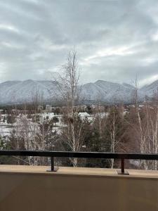 a view of snow covered mountains from a balcony at TERRA Vista Penthouse near Pirin Golf and Bansko in Razlog