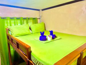 Postel nebo postele na pokoji v ubytování Siargao Zita's Garden Inn