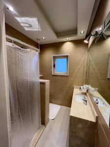 a bathroom with a shower and a sink at The H Cairo Suites in Cairo