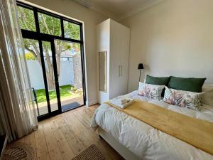 a bedroom with a large bed and a large window at Casa Montanari in Cape Town