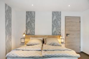 a bedroom with a large bed with two pillows at Pur Wohnen - Wohnung West in Bad Griesbach