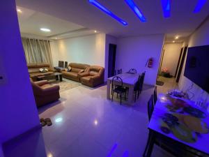 a living room with purple lights and a table at stay with sonu in Dakar