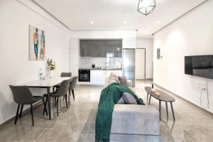 a living room with a couch and a table at Cozy Home With Cooking Near Tram in Piraeus