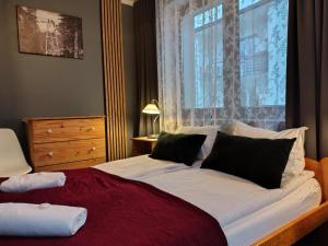 a bedroom with a large bed with a large window at Willa na Wilcznik in Zakopane