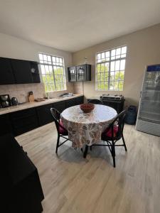 a kitchen with a table and chairs in a room at Appartement Lili in Grand-Baie