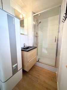 a bathroom with a sink and a shower at Bungalow Océane in Léon +13 photos