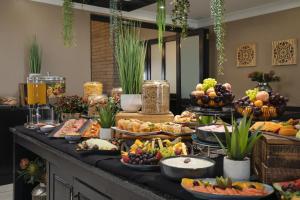 a buffet with many different types of food on a table at Protea Hotel by Marriott Bloemfontein in Bloemfontein +45 photos