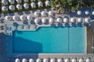 an overhead view of a swimming pool with chairs at Atlantica Sungarden Park in Ayia Napa