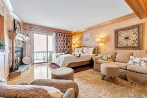 a large room with a bed and a couch at Cozy Studio Wood Fireplace in Ellicottville