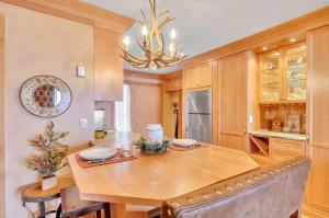 a dining room with a wooden table and a chandelier at Cozy Studio Wood Fireplace in Ellicottville +21 photos